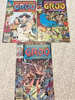 All three Groo comic books laid out, showing covers