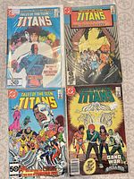 Four bagged Teen Titans comics laid out