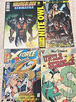 Four comics laid out: Youngblood Strikefile #1, Before Watchmen Nite Owl, X-Force #26, Uncle Scrooge #270