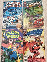 Group shot of all four bagged comics: Captain America, Untold Tales of Spider-Man, Cloak & Dagger, Daredevil