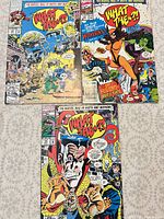 Three "What The--?!" comics laid out