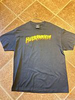 Front of black Hulkamania T-shirt laid flat