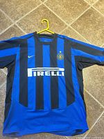 Full front view of jersey showing color pattern, sponsor, swoosh and size indication