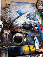 Overview of work surface with hammer, screwdrivers, zip ties bag, tapes and accessories