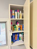 Three-shelf cabinet of assorted sun care products