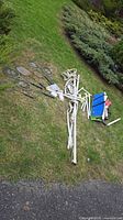 Full lot on grass showing rackets, poles, net, shuttlecocks, carry bag