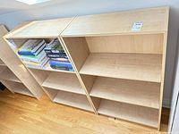 Top view of both light maple bookcases side by side showing shelves and finish