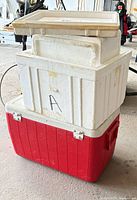 Stacked Styrofoam chest inserts atop red Coleman cooler