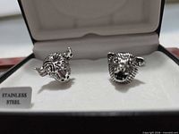 Open box showing bull and bear novelty head cufflinks