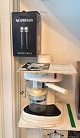 Overall view of EX-106 machine with carafe, portafilter, Aeroccino 3 box and booklet
