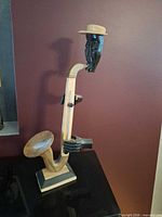 Front view of carved wooden saxophonist sculpture