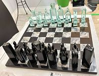 Overall view of glass chess set showing board and pieces