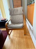 Front view of Poäng chair showing frame and cushions