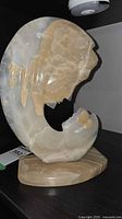 Front view of onyx and alabaster sculpture on stone base
