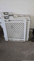 Stack of three Safety 1st plastic room divider panels