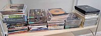 Wide view of four stacks of mixed media discs on shelf