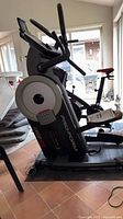 Full view of ProForm Cardio HIIT elliptical trainer on base platform