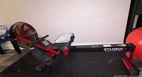 Full side view of Stamina X air rower on rubber mat