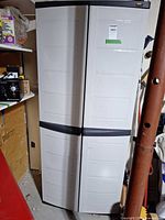 Full front view of tall white Rubbermaid cabinet