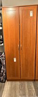 Front view of closed cherry laminate cabinet
