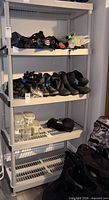 Front view of the four-shelf plastic rack loaded with items