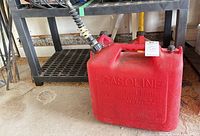 5 gallon Wedco red plastic gasoline can with spout showing overall condition