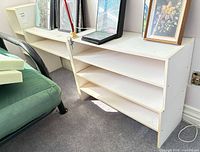 Three shelving units side by side; low horizontal units and taller narrow unit visible