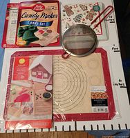 All items in lot: silicone baking mat, candy molds, sifter, counter cover, napkins