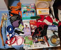 Full lot overview with diapers, leashes, collars, bowls, wipes, brushes, food samples and costume