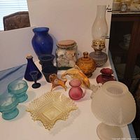 Group shot of all colored glassware, lamp parts and figurines