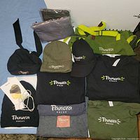 Full lot overview showing shirts, aprons, hats