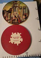 Top view showing assembled Epiphany puzzle and box lid of Little Red Riding Hood's Hood with measuring scale