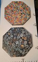 Top view of both completed puzzle images, Postage Paid stamp collage and Pine Arden Wood pinecone scene