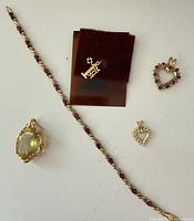 Group shot of bracelet and four pendants on white background
