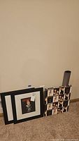 Overall view: two black frames, Playboy collage canvas, grey poster tube
