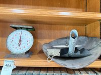 Both scales on shelf: hanging scale pan and countertop scale visible