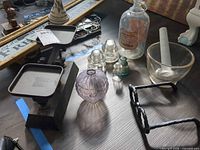 Lot overview showing scale, insulators, bottle, hobnail vase, mortar & pestle