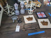 Overview of lot showing crowns, finials, plaques, key, crest, framed print and tag