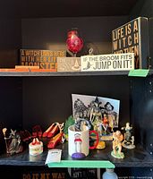 Shelf showing wood signs, wine glass, hanging bottle