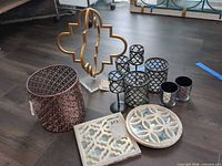 All items grouped together showing votive holders, mirrored plaques, wastebasket and sculpture