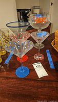 Group shot of five promotional cocktail glasses on table