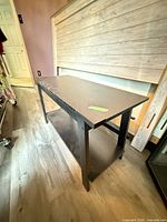 Full view of black console table with lower shelf