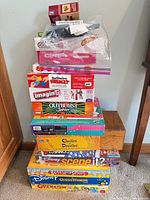Stacked view of all boxed games including Connect 4 through Operation