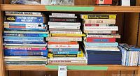 Full shelf view of three stacks of assorted books and magazines