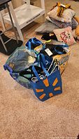 Overview of tote bags containing clothing and hangers