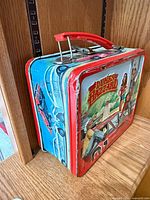 Side view of Dukes of Hazzard metal lunchbox showing graphics and handle