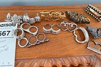 Wide shot showing all rings laid out on wooden surface