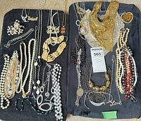 All necklaces laid out on two black boards