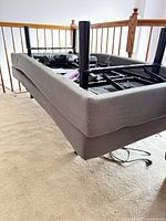 Entire adjustable bed base upside down showing frame, legs, wiring