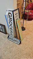 Group of five signs leaning together showing sizes and colors